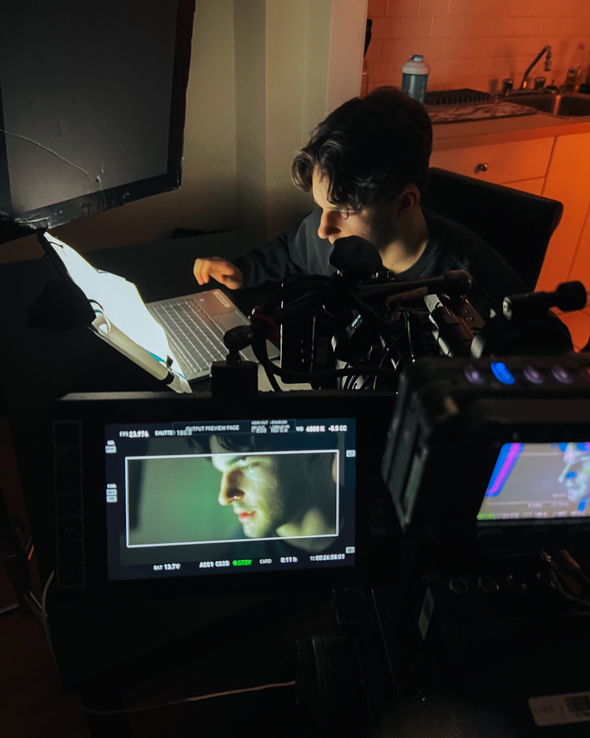 Gabriel reviewing a scene beside cinema cameras and production monitors